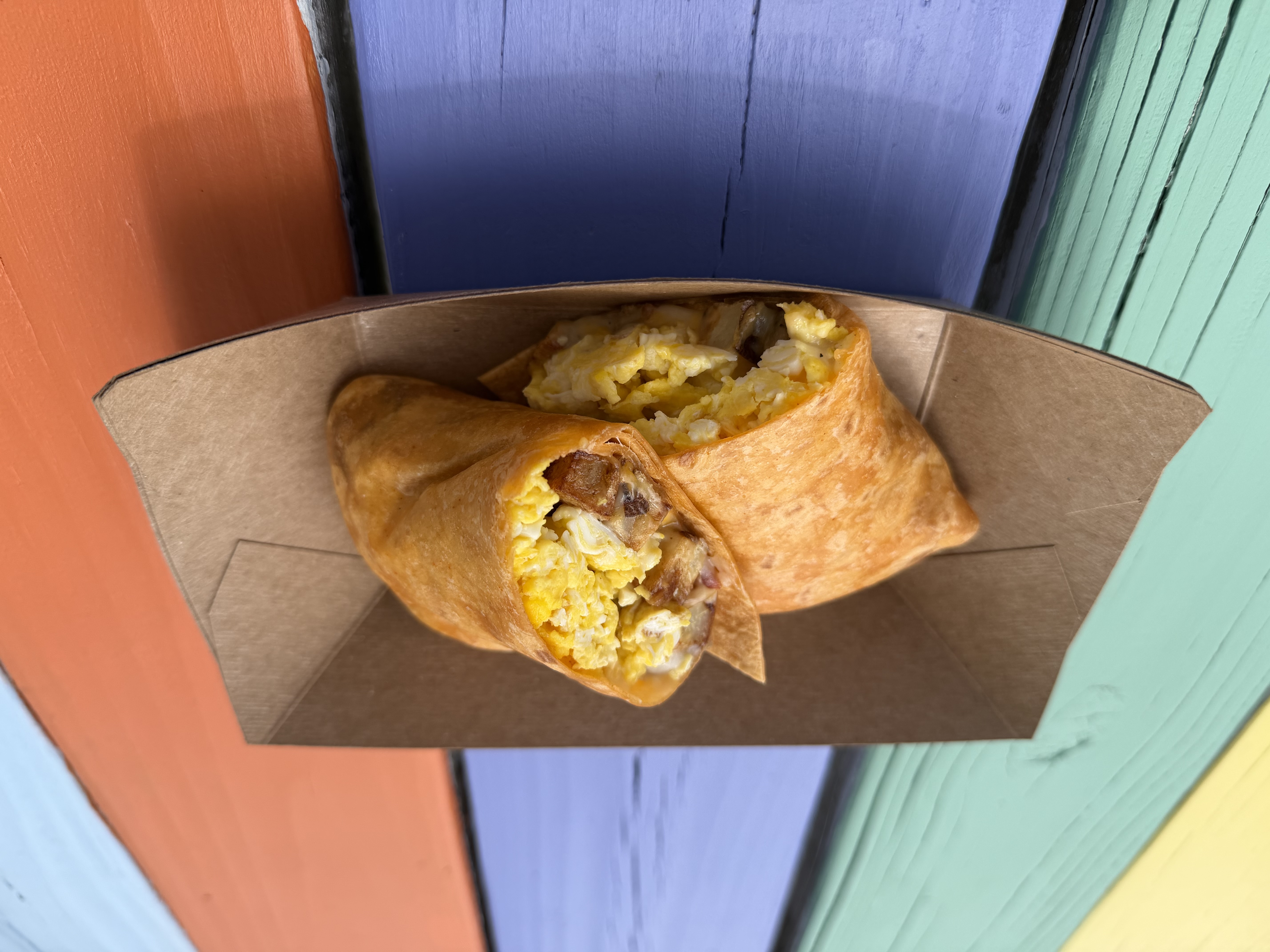 Burrito of Love breakfast burrito with scrambled eggs, sausage, bacon, potatoes, Cheddar Jack cheese, and white pepper gravy