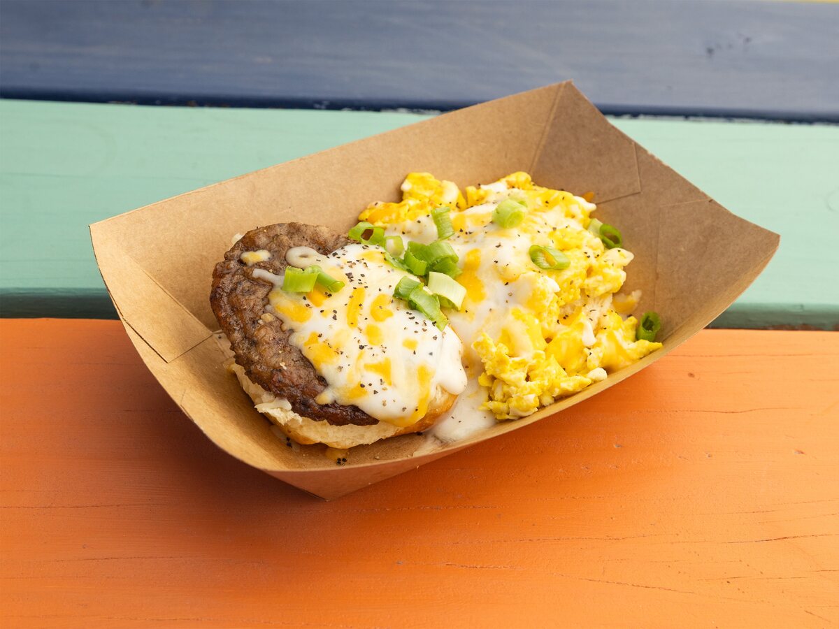 The Hammer open-faced biscuit Austin breakfast with eggs, meat, cheese, and gravy from Biscuits + Groovy